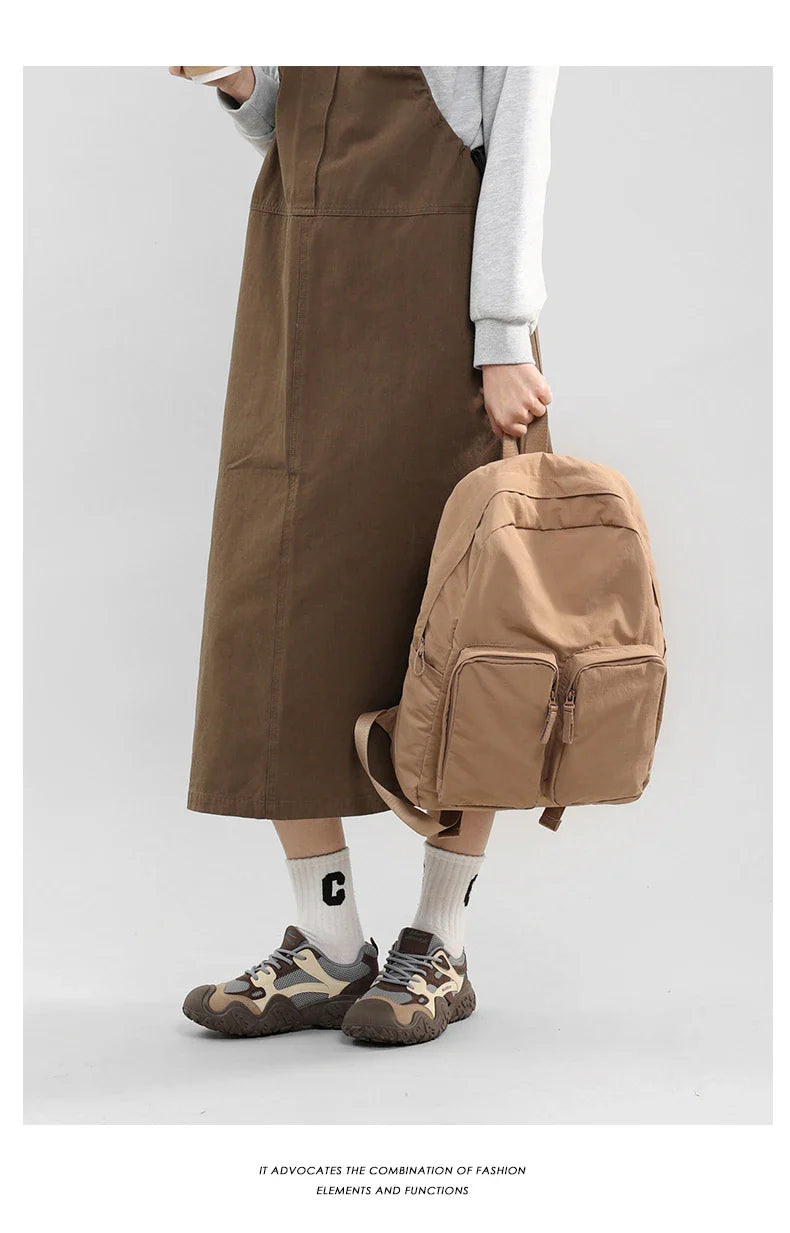 Water - resistant double - shoulder backpack. It has a large capacity, is lightweight and casual. Made of wrinkled and washed ny